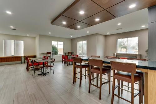a dining room with a large table and chairs at Holiday Inn Express & Suites Waxahachie by IHG in Waxahachie