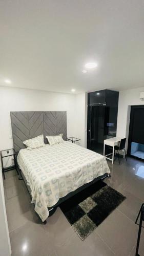 a bedroom with a large bed and a table at Ergosuites in Figueira da Foz