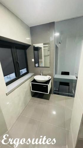 a bathroom with a sink and a mirror at Ergosuites in Figueira da Foz