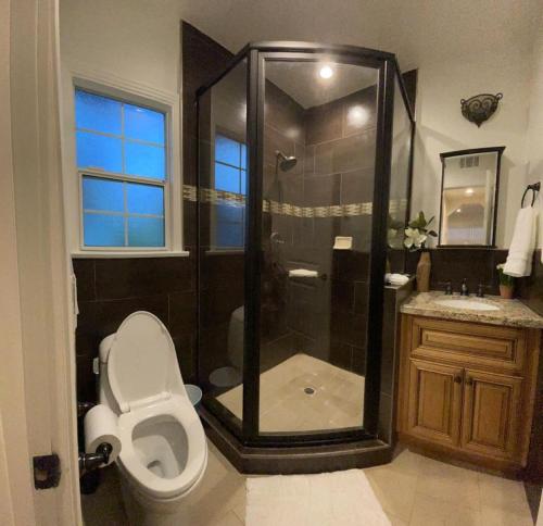 a bathroom with a shower and a toilet and a sink at Luxury Suite near Universal Studios in Los Angeles
