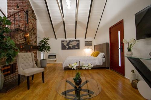 a bedroom with a bed and a table in a room at Dreamy Farmhouse in Studio City in Los Angeles