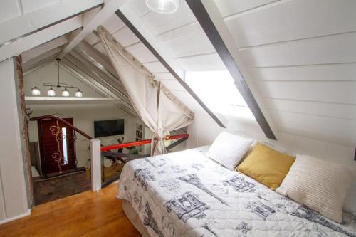 a bedroom with a bed in a attic at Dreamy Farmhouse in Studio City in Los Angeles