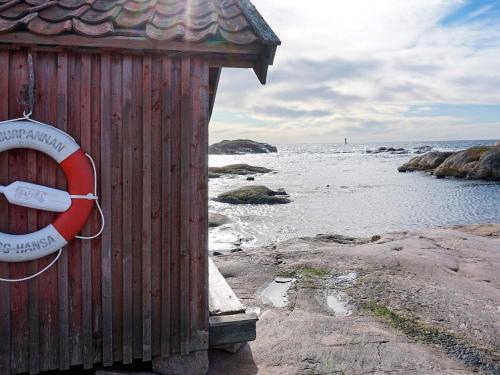 a sign on the side of a wooden building next to the water at 8 person holiday home in Grebbestad-By Traum in Grebbestad