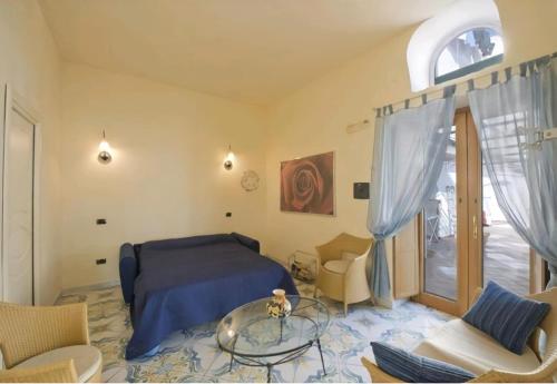 a bedroom with a bed and a glass table at Terrazza di Rosa - sea view in Praiano