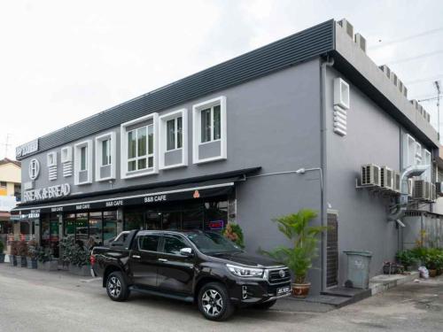 a black truck parked in front of a building at Hope Hotel Masai in Masai