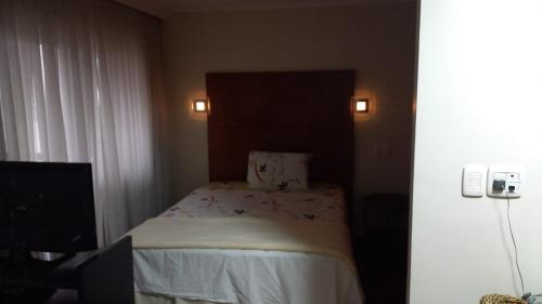 En eller flere senge i et værelse på Flat em Hotel de Luxo no Itaim