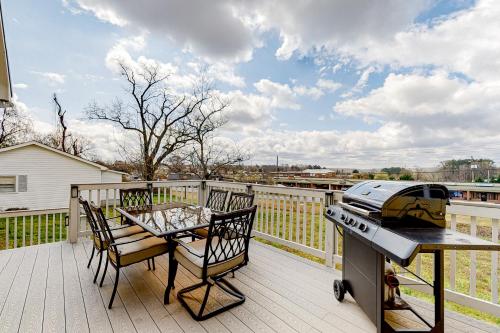a grill and a table and chairs on a deck at Holbert House in Jasper