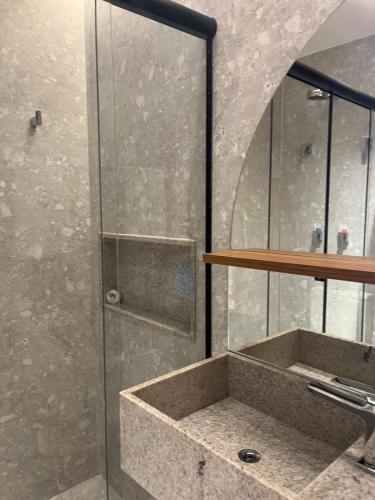 une salle de bain avec un lavabo et une douche en verre dans l'établissement Salinas Premium Resort - Salinópolis PA, à Salinópolis