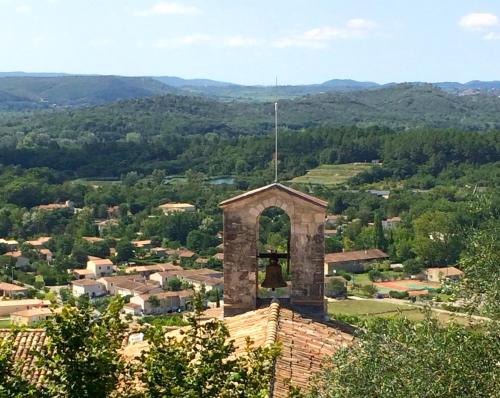 a building with a bell tower on top of a city at L'Autre Maison in Saint-Jean-de-Ceyrargues