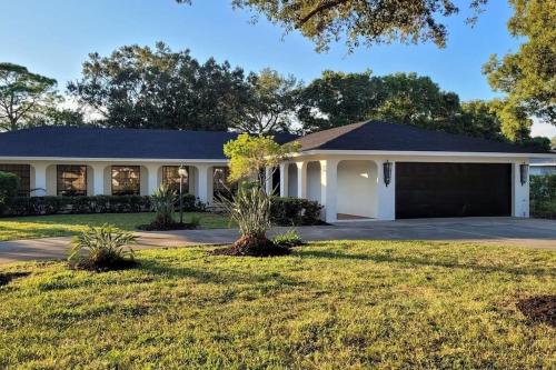 a large house with a garage at Remodeled 4BR Pool Home / Golf View/Near Beaches in Sarasota
