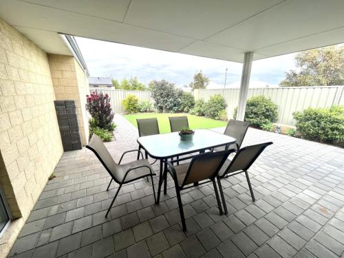 a table and chairs sitting on a patio at Napolean Holiday Retreat in Vasse