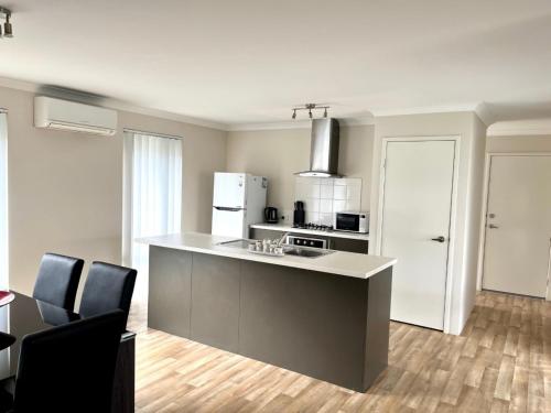 a kitchen with a stove and a counter top at Napolean Holiday Retreat in Vasse