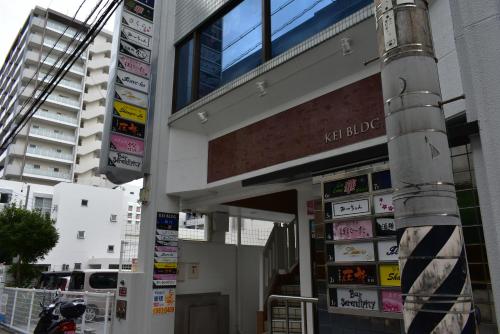 a building with signs on the side of it at GEORGE HOUSE in Tsuji in Naha