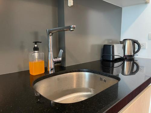 a sink in a counter with a glass of orange juice at LAGUNA BEACH 3 MALDIVES in Jomtien Beach