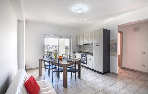a kitchen and dining room with a table and chairs at Gorgeous Apartment In Nicotera Marina in Nicotera Marina