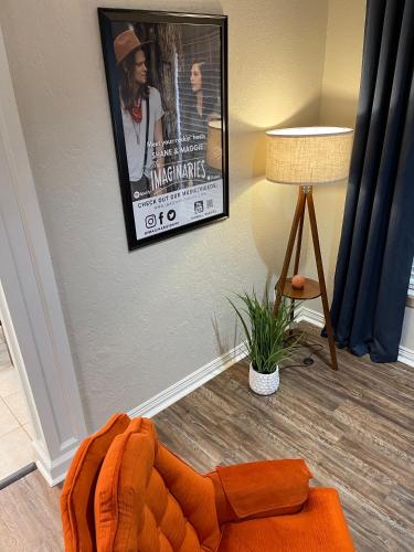 a picture of a movie hanging on a wall at The Drover House by USAO in Chickasha, Fenced Yard, King Bed, Smart TV, High Speed WIFI & Covered Parking in Chickasha