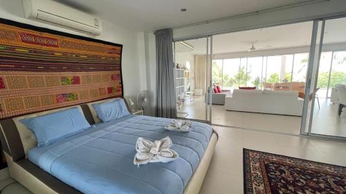 a bedroom with a blue bed with flowers on it at Kata Top Villas in Kata Beach