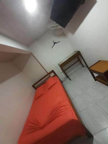 a bedroom with a red bed in a room at Hotel Panorama Neiva in Neiva