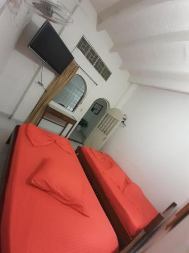 a room with a red suitcase and a window at Hotel Panorama Neiva in Neiva