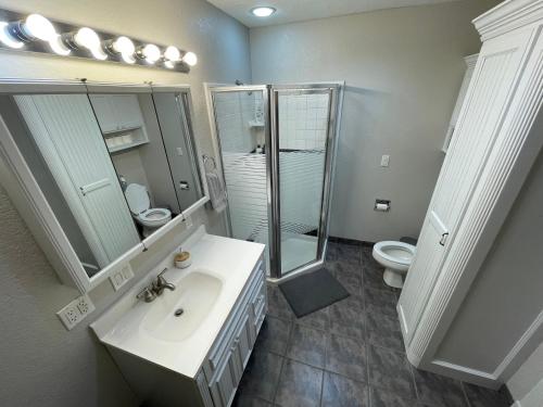 a bathroom with a sink and a shower and a toilet at The Drover House by USAO in Chickasha, Fenced Yard, King Bed, Smart TV, High Speed WIFI & Covered Parking in Chickasha