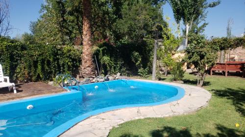 a swimming pool in a yard with a landscaping at Casa en chacras de Coria in Ciudad Lujan de Cuyo