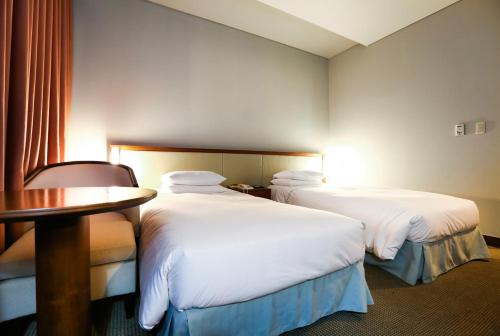 Postel nebo postele na pokoji v ubytování Mayfield Hotel Seoul