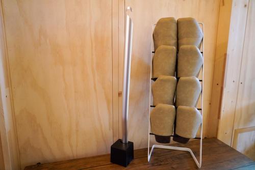 a towel rack with a bunch of towels at JR Mobile Inn Sapporo kotoni in Sapporo