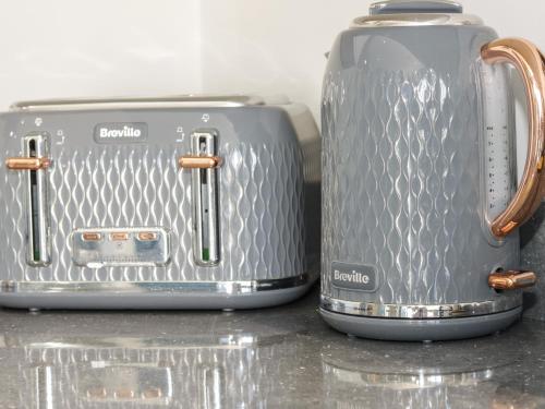two toasters sitting next to each other on a counter at 4 Parc Delfryn in Llanallgo
