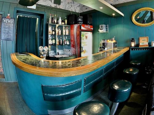 a blue bar with stools in a restaurant at Penzion Uno in Hradec Králové