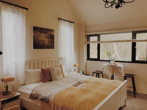 a bedroom with a large bed and a window at Artvilla Village in Xihu