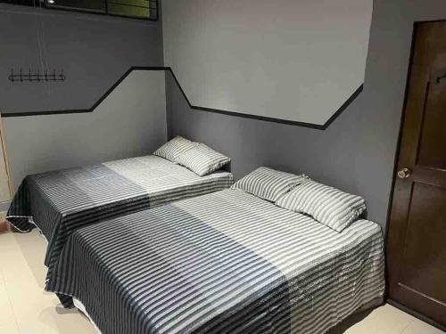 2 Betten nebeneinander in einem Zimmer in der Unterkunft Hermoso Huehueloft2 con estacionamiento y wifi in Huehuetenango