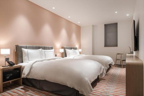 Un ou plusieurs lits dans un hébergement de l'établissement Phoenix Hotel Taichung