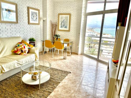- un salon avec un canapé et une table dans l'établissement Apartamento Torre de la Roca Torremolinos, à Torremolinos