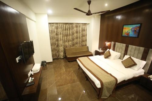 a hotel room with a bed and a window at The Byke Heritage Resort - Matheran in Matheran