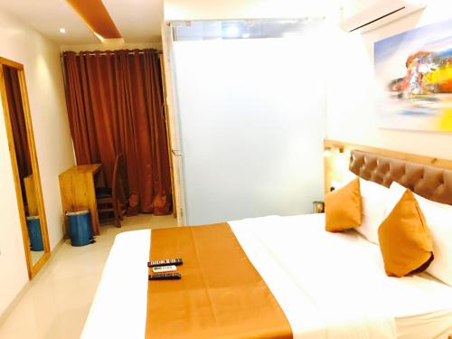 a bedroom with a bed with a wooden table on it at Hotel Grandeur-Near Mumbai International Airport in Mumbai