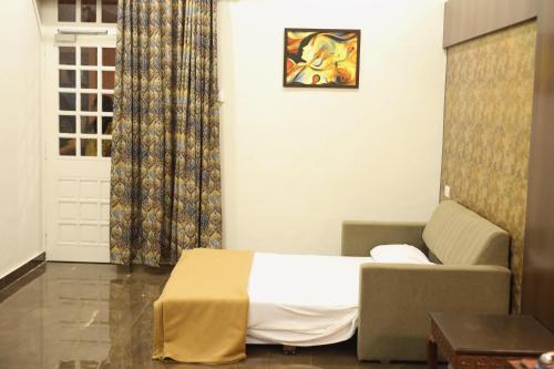 a hotel room with a bed and a couch at The Byke Heritage Resort - Matheran in Matheran