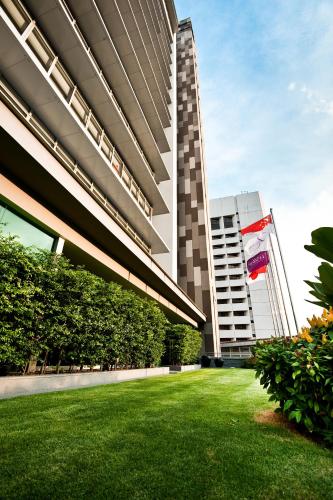 a large building with a lawn in front of it at Wilby Central Serviced Apartments in Singapore