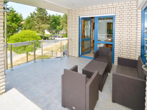 a patio with chairs and tables on a building at Ferienhaus Binz - Apt. 01 in Binz