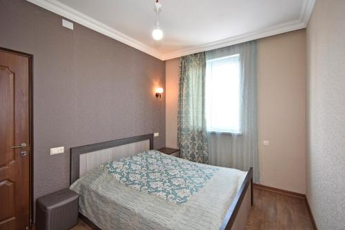 a small bedroom with a bed and a window at Apartment for guest A2 in Yerevan