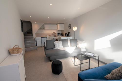 a living room with a couch and a table at CABANA & Duplex - Cluny à 20 minutes in Saint-Bonnet-de-Joux
