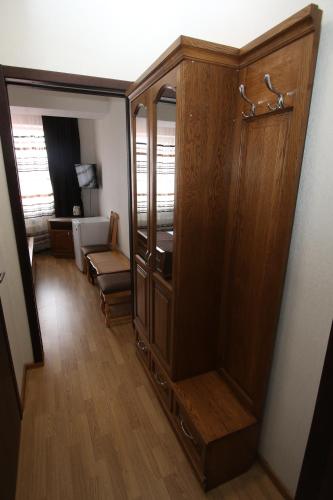 a room with a large wooden cabinet in a room at BAYKA - SPA resort in Kosiv