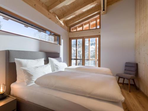 two white beds in a room with a window at Penning.Tirol in Hopfgarten im Brixental