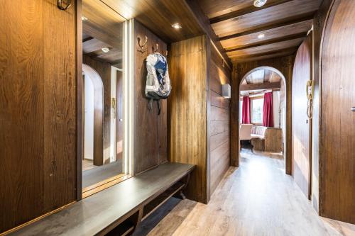 a hallway with wood paneling and a bench in a house at Hotel Landgasthof Gappen in Kramsach