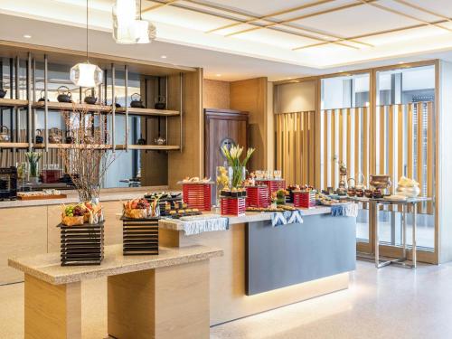 a lobby with a counter with food on it at Pullman Dali in Dali