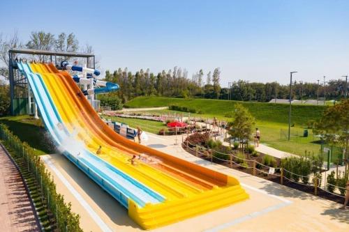 a roller coaster in a park with a slide at Estivo Premium Plus mobile homes on Camping Pra delle Torri in Caorle