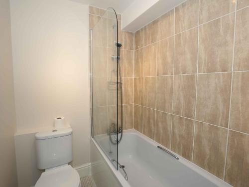 a bathroom with a shower and a toilet and a tub at Pass the Keys Newly Renovated 1 Bedroom Apartment Scarborough in Scarborough