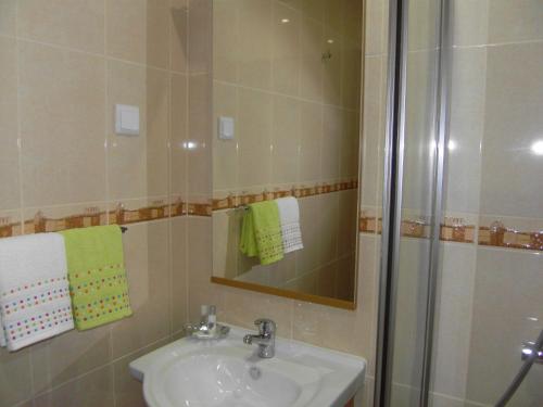 a bathroom with a sink and a shower at Muralha House in Lagos