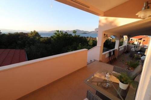a balcony with a table and a view of the ocean at Apartments Sergej in Drače