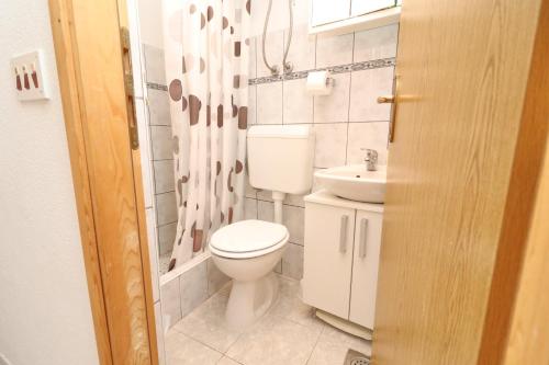 a bathroom with a toilet and a sink at Apartments Sergej in Drače