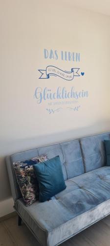 a living room with a couch with a sign on the wall at Ferienwohnungen Bergpanorama in Bad Mitterndorf